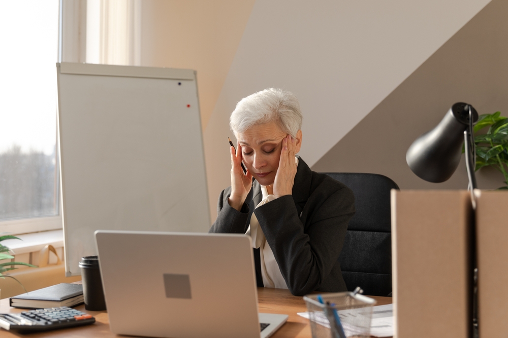 Senior,Woman,Touching,Temples,Experiencing,Stress,In,Office.,Mature,Lady