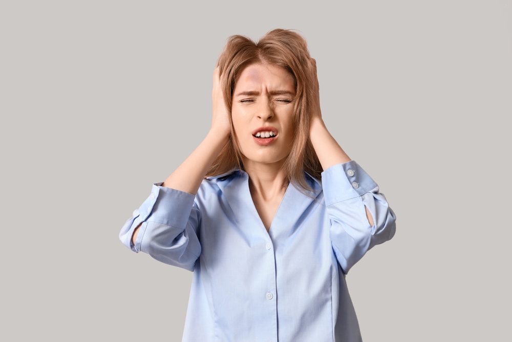 Young,Woman,With,Brain,Concussion,On,Light,Background