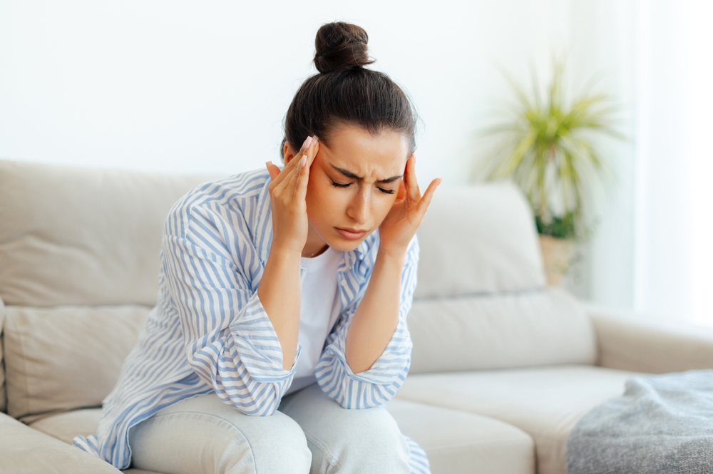 Stress,,Headache,,Illness.,Upset,Mixed,Race,Woman,Sitting,On,A